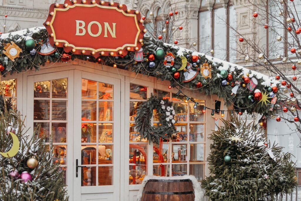 A snowy storefront decorated for Christmas